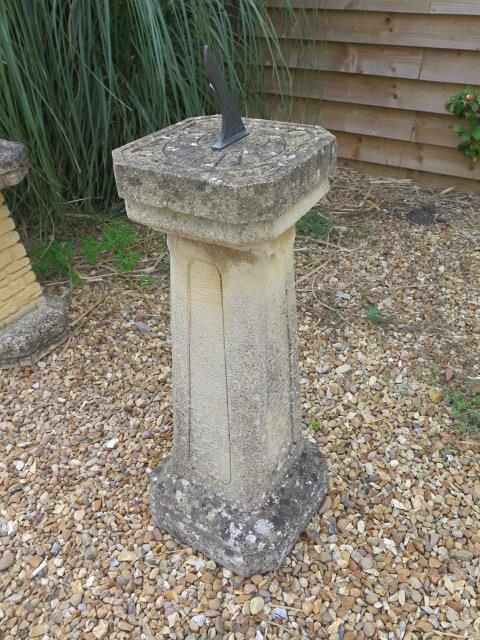 A stone effect sun dial, 98cm tall