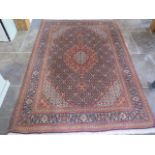 A hand woven woollen fine Tabriz rug, Mahi design, small worn patch but otherwise good, colours