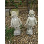 A pair of stone effect statues, 62cm tall