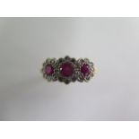 A hallmarked 18ct yellow gold ruby and diamond ring, the centre ruby approx 3.5mmx 2.5mm, ring