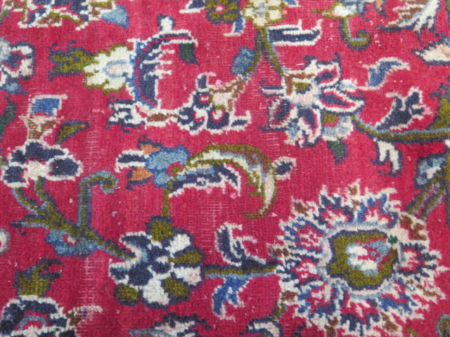 A hand woven large red ground Persian woollen Kashan carpet, 405cm x 284cm, some wear consistent - Image 3 of 6