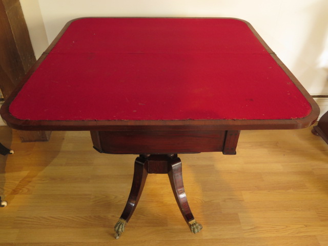 A 19th century mahogany foldover card table on four pillar support and splayed legs on brass hairy - Image 5 of 5