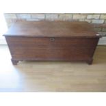 A 19th century oak coffer storage box with an internal candle box with a well figured top, 51cm tall