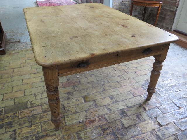 A Victorian stripped pine table with two end drawers and a side drawer on turned legs, 77cm tall x - Image 2 of 4