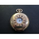 An 18ct yellow gold half hunter pocket watch marked 18K with an engraved back and 18ct gold dust