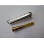 A cheroot holder with an 18ct gold collar in a silver case, case length 7cm, generally good, some