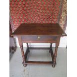 An 18th century and later oak side table with a drawer on turned supports united by all round