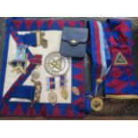 Two silver gilt and enamel masonic jewels, two gilt jewels, two sashes and an apron