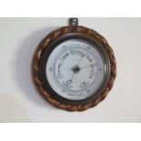 An oak aneroid barometer Riddels Limited Belfast, 23cm diameter, generally good condition