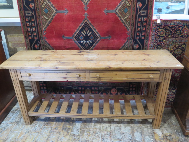 A modern pine two drawer dresser base with a pot board base 76 cm tall 168 by 44