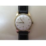 A Cyma 9ct gold Cymaflex manual wind wristwatch with 30mm case on a black leather strap, running and