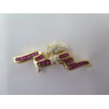 An 18ct yellow gold diamond and ruby brooch approx 4.5 grams, marked 750, 3.6 cm long, in good