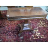 A 19th Century mahogany fold over tea table on a quartefoil base with claw feet 72cm tall by 92