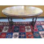 A Victorian inlaid stretcher table on turned pillar supports, 70cm tall x 99cm x 55cm, some losses