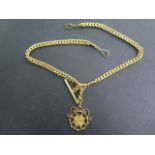 A yellow gold double Albert watch chain with pendant, tests to approx 18ct, marked 21c to a ring
