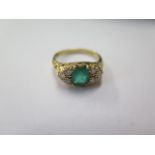 An 18ct hallmarked emerald and diamond ring, size M, approx 2.3 grams, in good condition, emerald