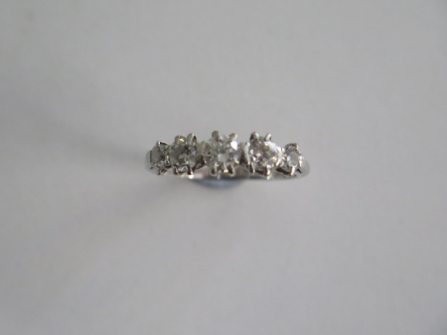 An 18ct white gold five stone diamond ring, size L, the centre stone approx 0.28ct, weight approx
