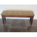 A new mahogany upholstered 19th century style window seat made by a local craftsman to a high