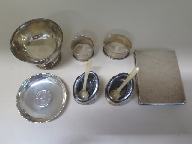 A pair of Continental silver salts, two silver napkin rings (one damaged), a silver bowl, coin