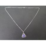 An 18ct white gold pendant on a 42cm 18ct white gold chain, pendant is 15mm wide, total weight