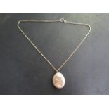 A gold plated locket on a 9ct hallmarked 38cm chain, weight of chain 3 grams, minor dents to