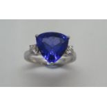 A good quality Tanzanite and diamond hallmarked 18ct white gold ring, size N/O, the trilliant cut