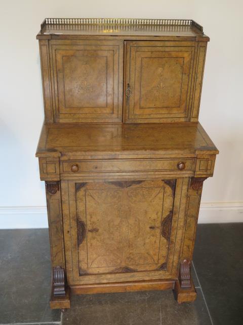 A good Victorian walnut writing desk with a two door brass galleried top with fitted interior