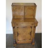 A good Victorian walnut writing desk with a two door brass galleried top with fitted interior