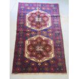 A new hand knotted woolen Baluchi rug 136 cm by 83 cm