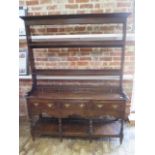 A 19th Century Oak dresser with an open rack top , five dummy small drawers above three frieze drawe