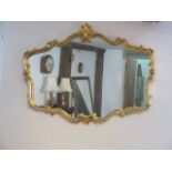 An ornate gilt framed modern mirror, 81cm x 107cm, in good condition