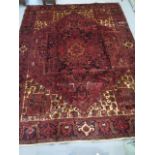 A hand knotted woollen Heriz rug, 3.31m x 2.51m, in good condition