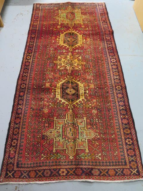 A hand knotted woollen Karajeh rug, 2.40m x 1.15m, in good condition