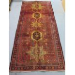 A hand knotted woollen Karajeh rug, 2.40m x 1.15m, in good condition