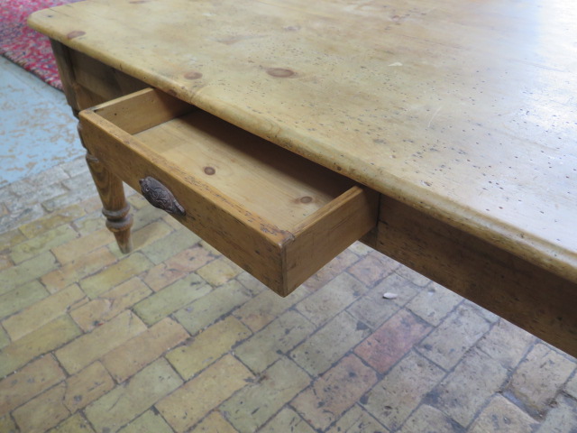 A Victorian stripped pine table with two end drawers and a side drawer on turned legs, 77cm tall x - Image 3 of 4