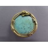 A Chinese unmarked gilt metal dragon brooch set with a turquoise stone and copper pin, 35mm x