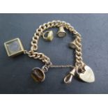 A 15ct yellow gold watch chain converted to a bracelet with 9ct clasp and assorted charms two as