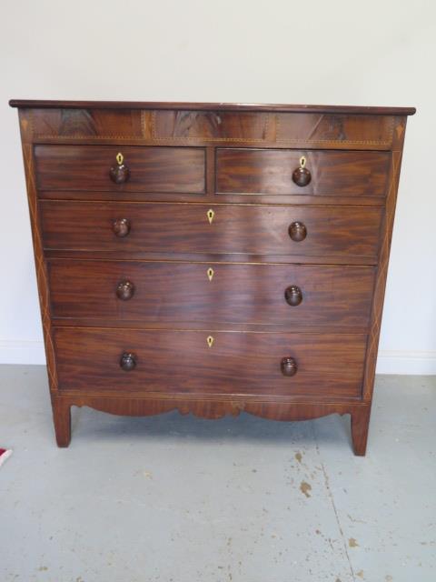 A 19th century mahogany five drawer chest with an inlaid frieze on bracket feet united by a shaped