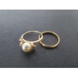 A 22ct band ring, size K, approx 2 grams, a14ct yellow gold pearl ring, size J, approx 2.5 grams