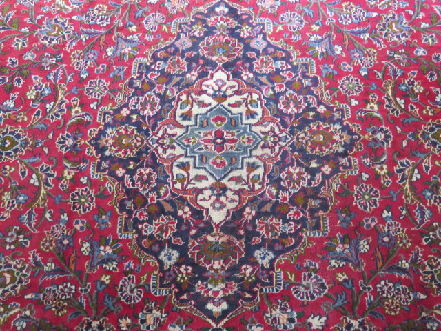 A hand woven large red ground Persian woollen Kashan carpet, 405cm x 284cm, some wear consistent - Image 2 of 6