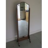 A 1930s oak cheval mirror in good polished condition, 152cm x 49cm
