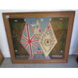 A WWI embroided wall hanging for the East Norfolk Regiment in a gilt frame, 68cm x 77cm, some damage