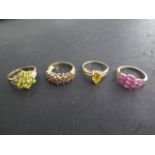 Four 9ct yellow gold rings, three are hallmarked, sizes J and N, total weight approx 9.4 grams