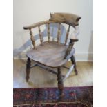 A Victorian smokers bow armchair with double turned stretchers