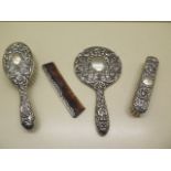 A silver embossed dressing table set, some wear and bending to comb but reasonably good