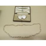 A pearl necklace with a 14ct gold clasp, 44cm long, and a silver heart brooch