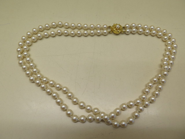 A double row of simulated pearls, approx size 6mm, all strung and knotted on thread and complete