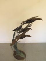 An Escar UK bronze water feature of four ducks in flight amongst the bullrushes, 128cm tall x