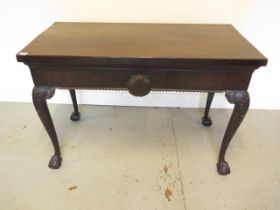 A mahogany serving silver table with carved shaped legs on ball and claw feet with shell carving,