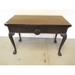 A mahogany serving silver table with carved shaped legs on ball and claw feet with shell carving,